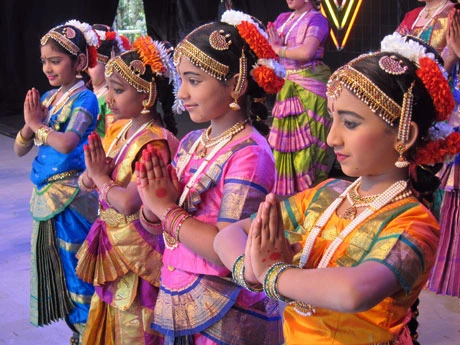 Image of four young girls in diwali dresses with their hands in a praying position